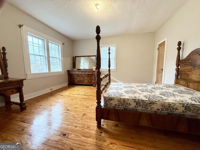 516 Longview St, Carrollton, GA 30117 - bedroom with light wood-style flooring and a textured ceiling