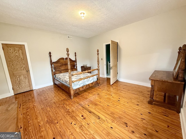 516 Longview St, Carrollton, GA 30117 - bedroom featuring a textured ceiling and wood finished floors
