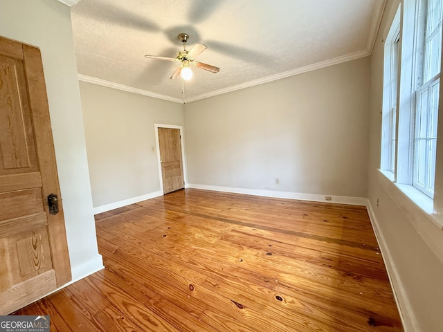 516 Longview St, Carrollton, GA 30117 - empty room featuring a ceiling fan, a textured ceiling, wood finished floors, and crown molding
