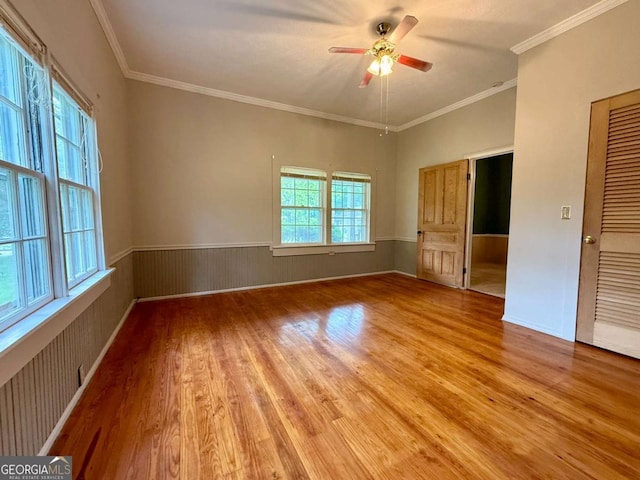 516 Longview St, Carrollton, GA 30117 - unfurnished room featuring light wood-style floors, ceiling fan, a wainscoted wall, and crown molding