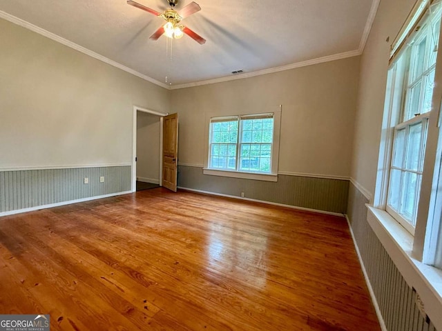 516 Longview St, Carrollton, GA 30117 - spare room featuring wood finished floors, wainscoting, crown molding, and a ceiling fan