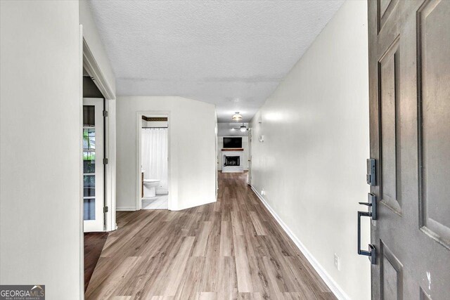 116 Overlook Bnd, Kingsland, GA 31548 - hallway featuring wood finished floors and a textured ceiling