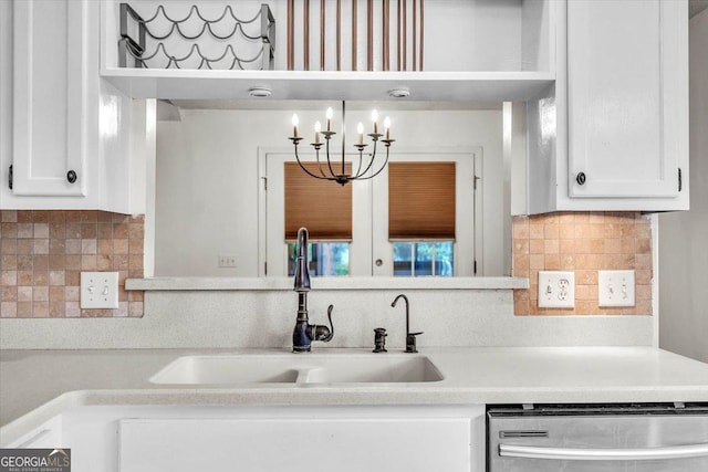 116 Overlook Bnd, Kingsland, GA 31548 - kitchen with stainless steel dishwasher, white cabinetry, and backsplash