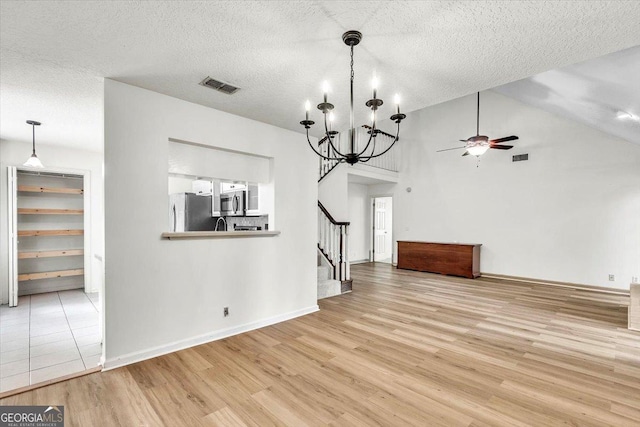 116 Overlook Bnd, Kingsland, GA 31548 - unfurnished dining area with a ceiling fan, wood finished floors, stairway, a textured ceiling, and a chandelier
