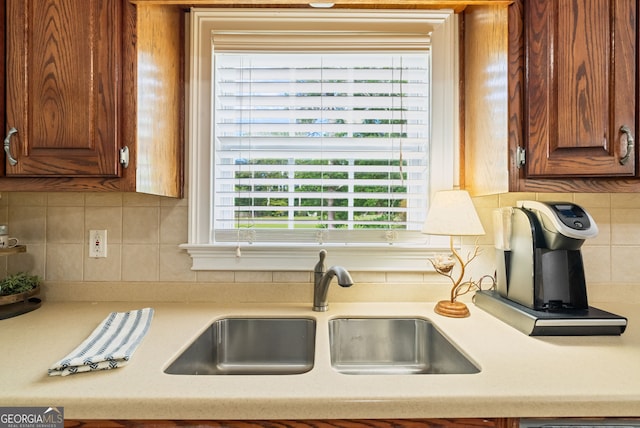 595 Mcgarity Dr, Mcdonough, GA 30252 - kitchen with light countertops, tasteful backsplash, and brown cabinetry