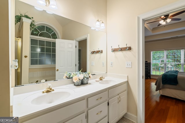 595 Mcgarity Dr, Mcdonough, GA 30252 - ensuite bathroom featuring double vanity, wood finished floors, ceiling fan, ornamental molding, and an enclosed shower