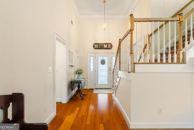 595 Mcgarity Dr, Mcdonough, GA 30252 - entrance foyer featuring a high ceiling, wood finished floors, crown molding, and stairs
