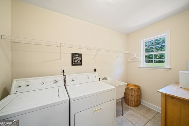 595 Mcgarity Dr, Mcdonough, GA 30252 - laundry room with washing machine and clothes dryer, light tile patterned floors, and cabinet space
