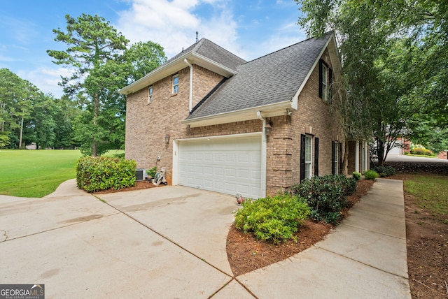 595 Mcgarity Dr, Mcdonough, GA 30252 - view of side of property featuring brick siding, a shingled roof, concrete driveway, and a yard