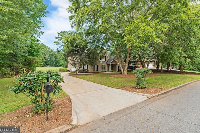595 Mcgarity Dr, Mcdonough, GA 30252 - view of property hidden behind natural elements with a front lawn and driveway