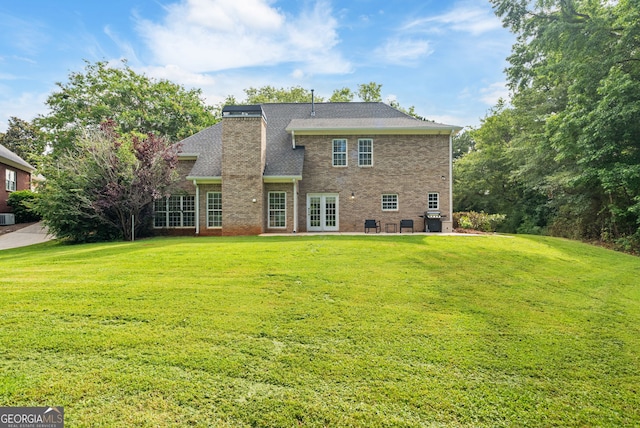 595 Mcgarity Dr, Mcdonough, GA 30252 - rear view of property featuring french doors, a yard, a patio area, and brick siding