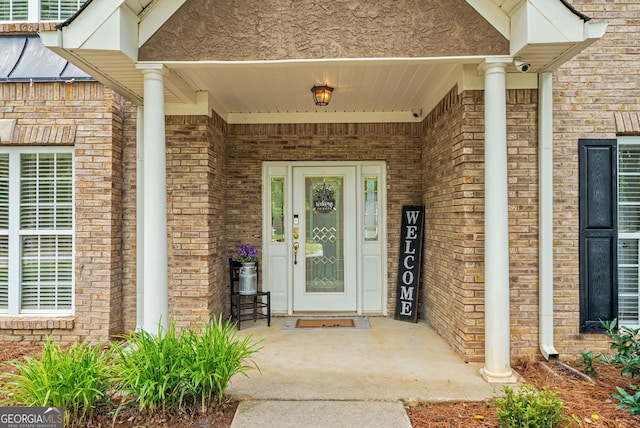 595 Mcgarity Dr, Mcdonough, GA 30252 - property entrance featuring brick siding, stucco siding, and covered porch