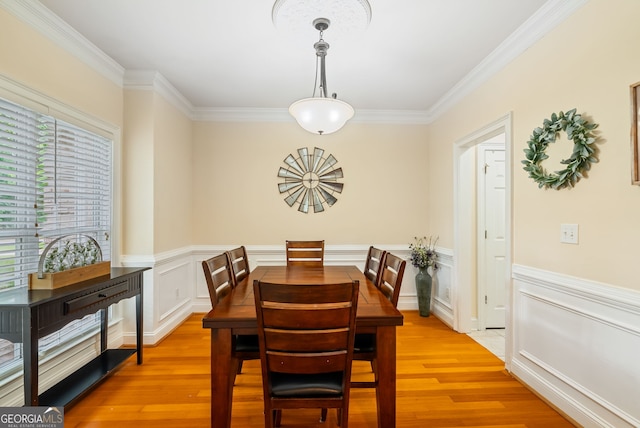 595 Mcgarity Dr, Mcdonough, GA 30252 - dining room with ornamental molding, light wood-style floors, a wainscoted wall, and a decorative wall