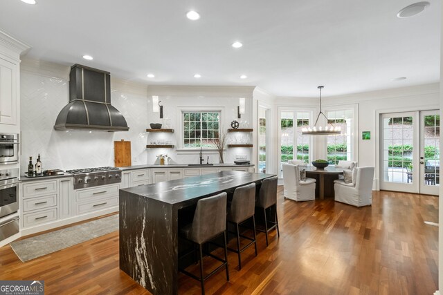 3401 Stillhouse Rd SE, Atlanta, GA 30339 - kitchen featuring custom exhaust hood, dark countertops, open shelves, wood finished floors, and recessed lighting