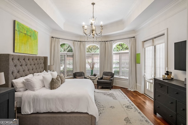 3401 Stillhouse Rd SE, Atlanta, GA 30339 - bedroom featuring a chandelier, crown molding, multiple windows, dark wood-type flooring, and a tray ceiling