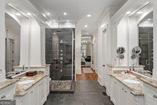 3401 Stillhouse Rd SE, Atlanta, GA 30339 - bathroom featuring a stall shower, crown molding, two vanities, tile patterned floors, and recessed lighting