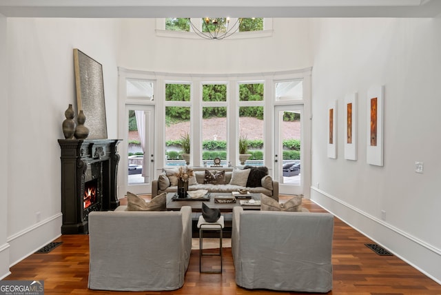 3401 Stillhouse Rd SE, Atlanta, GA 30339 - living area with dark wood-style flooring, a fireplace, and a towering ceiling