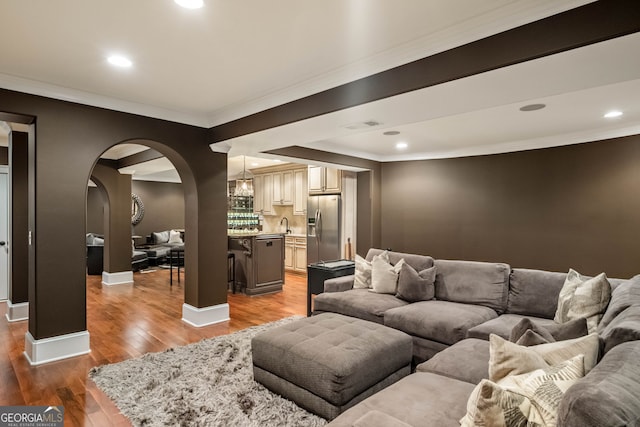 3401 Stillhouse Rd SE, Atlanta, GA 30339 - living room featuring arched walkways, ornamental molding, light wood-style flooring, and recessed lighting