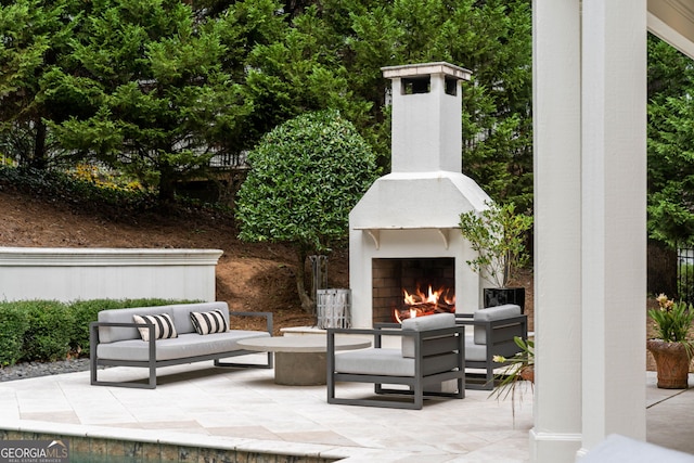 3401 Stillhouse Rd SE, Atlanta, GA 30339 - view of patio / terrace with an outdoor living space with a fireplace