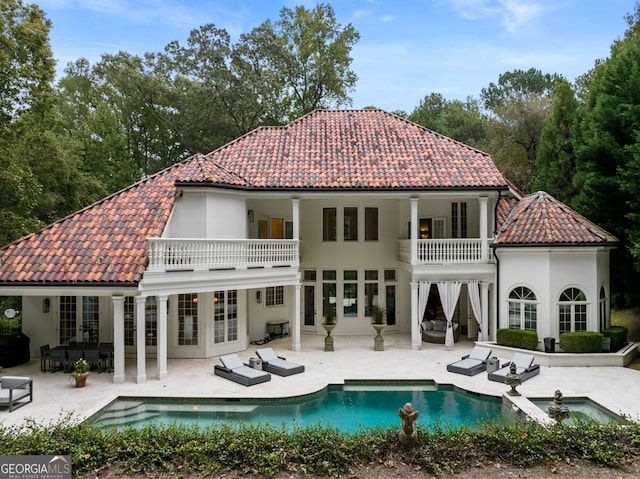 3401 Stillhouse Rd SE, Atlanta, GA 30339 - rear view of house featuring a balcony, a tiled roof, an outdoor living space, and a patio area