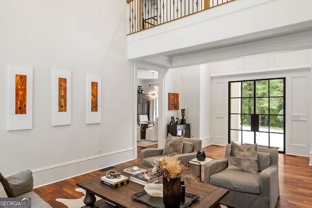 3401 Stillhouse Rd SE, Atlanta, GA 30339 - living room featuring a high ceiling, wood finished floors, and crown molding