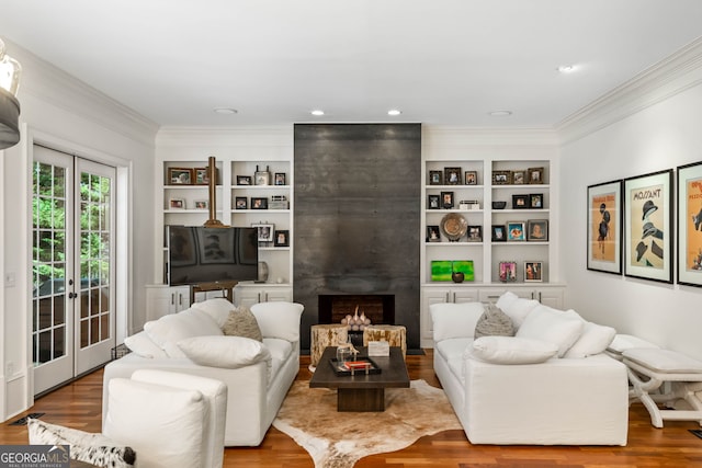 3401 Stillhouse Rd SE, Atlanta, GA 30339 - living room featuring crown molding, wood finished floors, built in features, and a fireplace