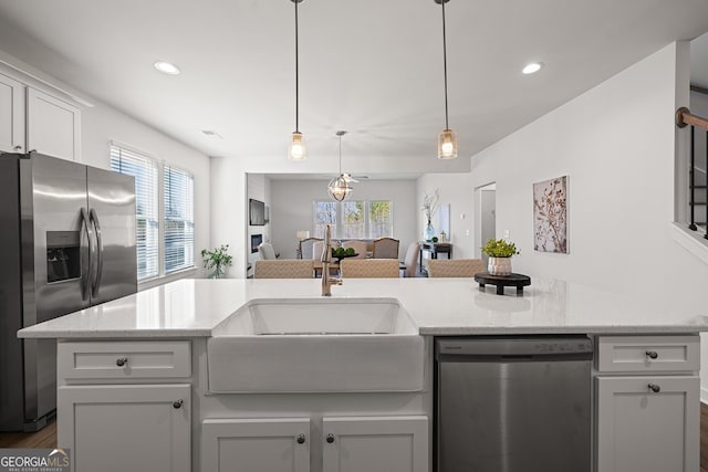 1313 Pj E Rd, Covington, GA 30014 - kitchen with stainless steel appliances, healthy amount of natural light, recessed lighting, light stone countertops, and open floor plan