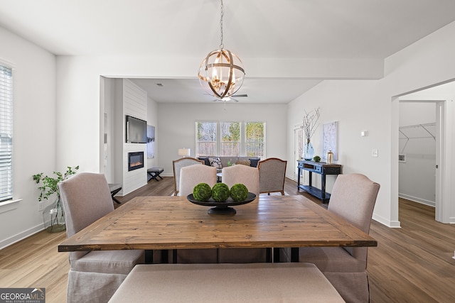 1313 Pj E Rd, Covington, GA 30014 - dining area with a chandelier, a fireplace, and wood finished floors