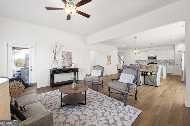 1313 Pj E Rd, Covington, GA 30014 - living room featuring ceiling fan, light wood finished floors, stairway, and recessed lighting