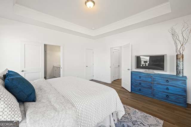 1313 Pj E Rd, Covington, GA 30014 - bedroom featuring a tray ceiling, dark wood-style flooring, ornamental molding, and ensuite bathroom