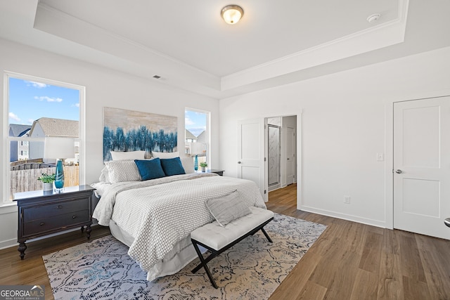 1313 Pj E Rd, Covington, GA 30014 - bedroom featuring a tray ceiling, wood finished floors, and ornamental molding