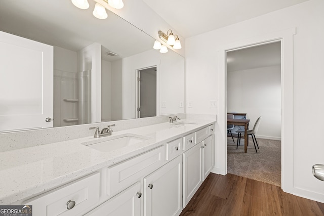 1313 Pj E Rd, Covington, GA 30014 - full bath with double vanity and wood finished floors