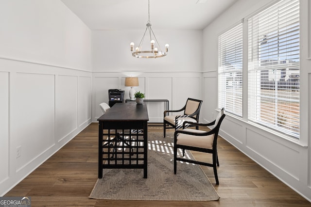 1313 Pj E Rd, Covington, GA 30014 - dining room with a decorative wall, a chandelier, dark wood-style flooring, and wainscoting