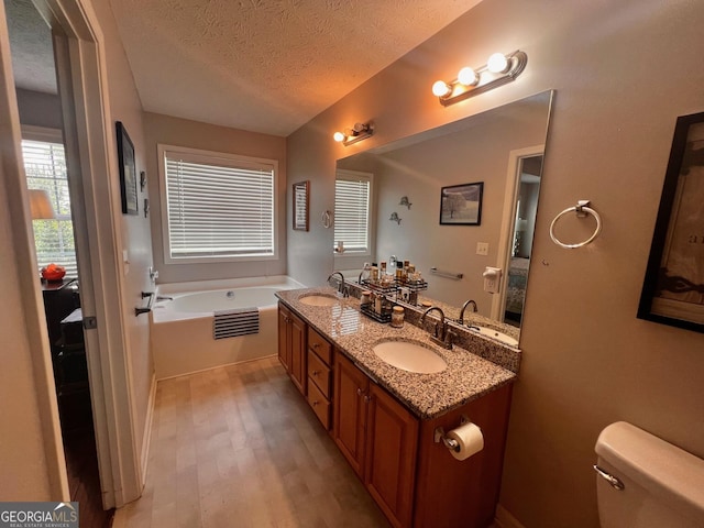 120 Summer Trc, Thomaston, GA 30286 - full bath featuring a textured ceiling, wood finished floors, double vanity, and a garden tub