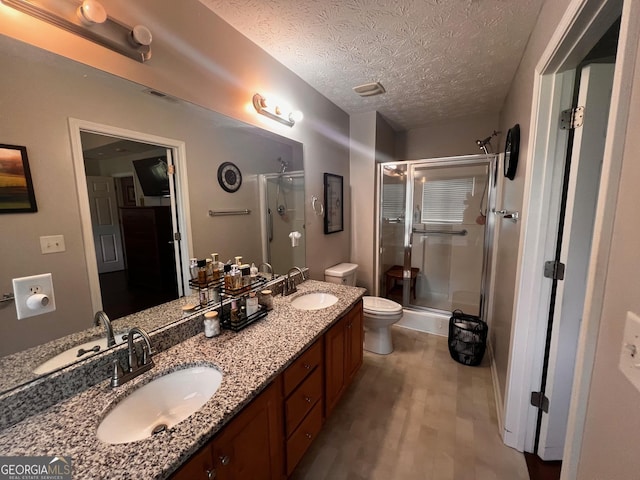 120 Summer Trc, Thomaston, GA 30286 - full bathroom with a shower stall, wood finished floors, double vanity, and a textured ceiling