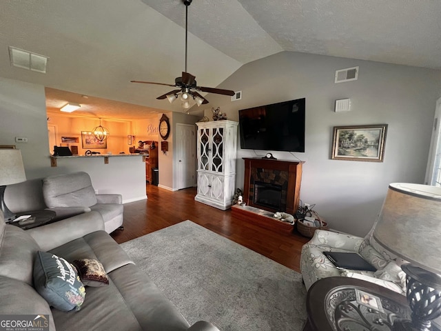 120 Summer Trc, Thomaston, GA 30286 - living area featuring lofted ceiling, dark wood finished floors, ceiling fan, and a glass covered fireplace