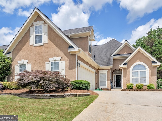 141 Wexford Ct, Stockbridge, GA 30281 - traditional home featuring stucco siding, concrete driveway, a shingled roof, a front yard, and an attached garage