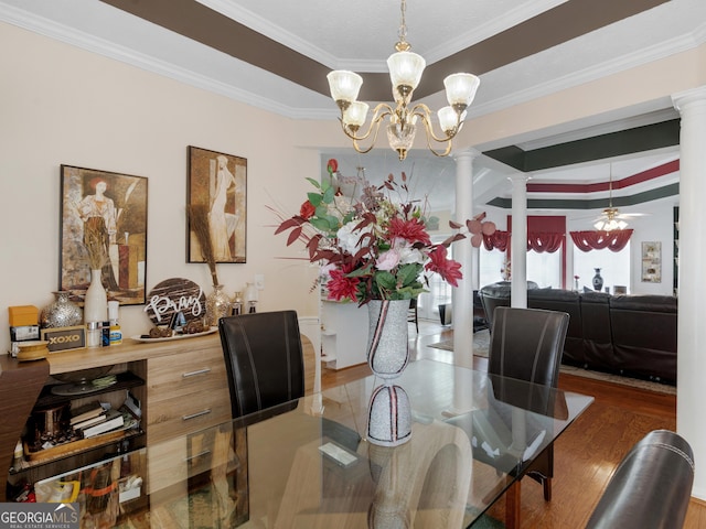 141 Wexford Ct, Stockbridge, GA 30281 - dining room featuring decorative columns, crown molding, a chandelier, wood finished floors, and a ceiling fan