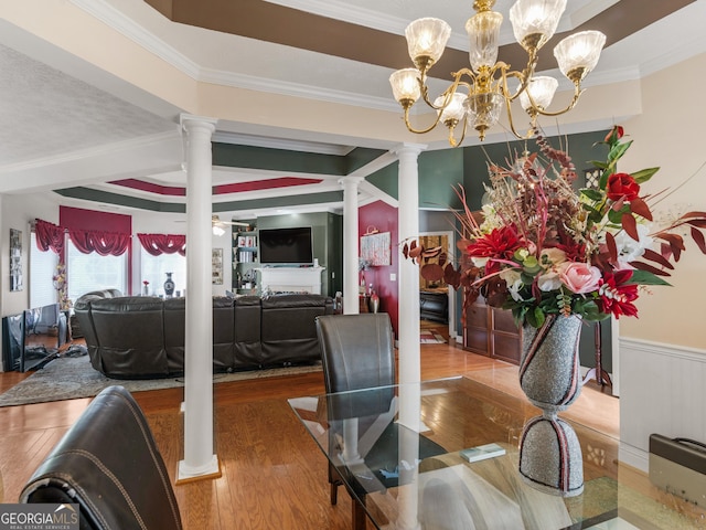 141 Wexford Ct, Stockbridge, GA 30281 - dining room featuring ornate columns, ornamental molding, wood finished floors, and a chandelier