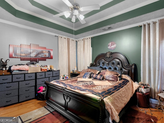 141 Wexford Ct, Stockbridge, GA 30281 - bedroom featuring wood finished floors, crown molding, a raised ceiling, and ceiling fan