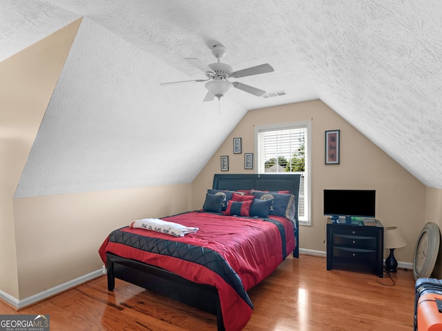 141 Wexford Ct, Stockbridge, GA 30281 - bedroom with a textured ceiling, wood finished floors, lofted ceiling, and a ceiling fan