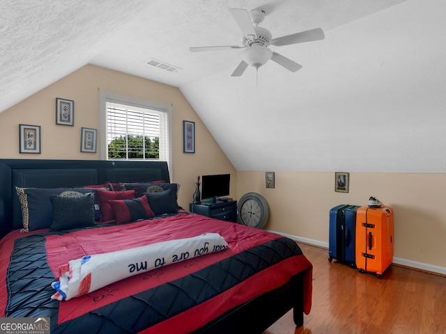 141 Wexford Ct, Stockbridge, GA 30281 - bedroom with wood finished floors, vaulted ceiling, a ceiling fan, and a textured ceiling