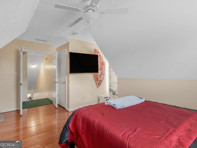 141 Wexford Ct, Stockbridge, GA 30281 - bedroom with wood finished floors, vaulted ceiling, and a ceiling fan