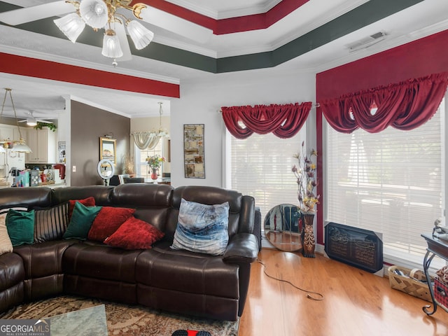 141 Wexford Ct, Stockbridge, GA 30281 - living room with ornamental molding, wood finished floors, a ceiling fan, and a chandelier