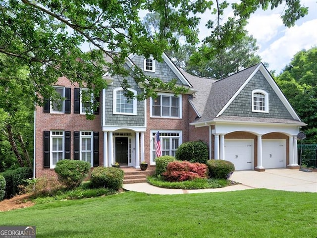 658 Vinings Estates Dr SE, Mableton, GA 30126 - shingle-style home with concrete driveway, a front yard, brick siding, and roof with shingles