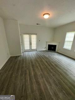 3609 Ginnis Rd SW Unit 6, Atlanta, GA 30331 - unfurnished living room with wood finished floors, a fireplace, and french doors