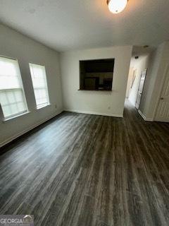 3609 Ginnis Rd SW Unit 6, Atlanta, GA 30331 - unfurnished living room with wood finished floors