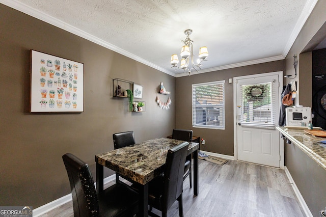 105 N River Dr Unit G, Sandy Springs, GA 30350 - dining space featuring a chandelier, light wood-style flooring, a textured ceiling, and ornamental molding