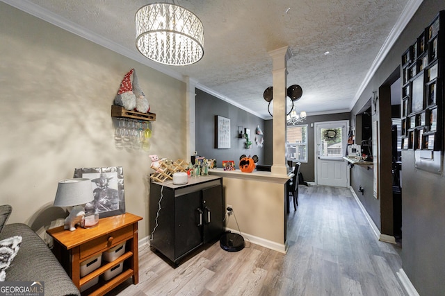 105 N River Dr Unit G, Sandy Springs, GA 30350 - kitchen featuring a chandelier, wood finished floors, ornamental molding, and a textured ceiling