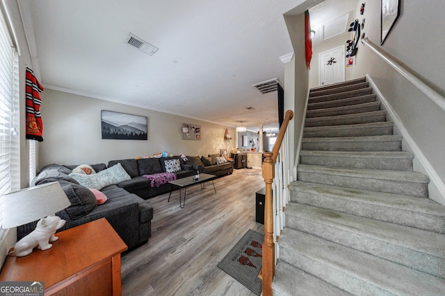 105 N River Dr Unit G, Sandy Springs, GA 30350 - living area featuring stairway, wood finished floors, and crown molding